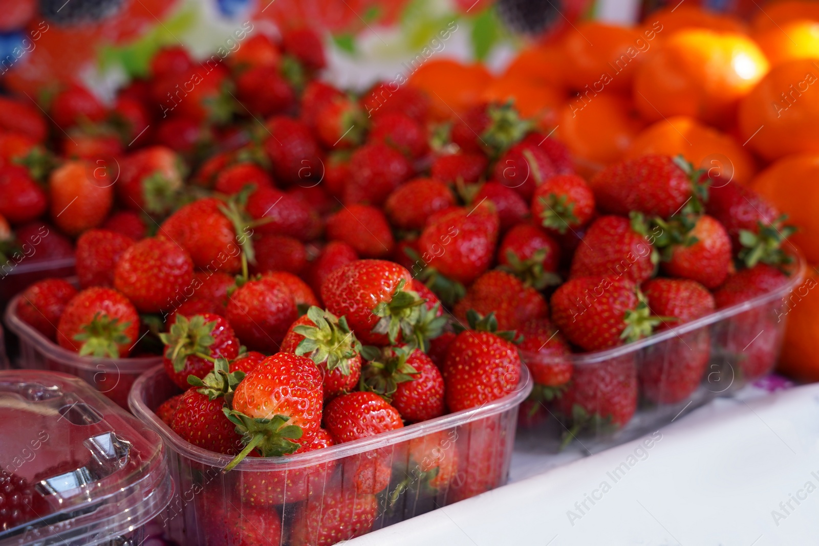 Photo of Fresh ripe strawberries on counter at market, closeup