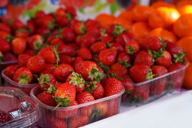 Photo of Fresh ripe strawberries on counter at market, closeup