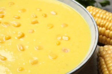 Delicious creamy corn soup on table, closeup