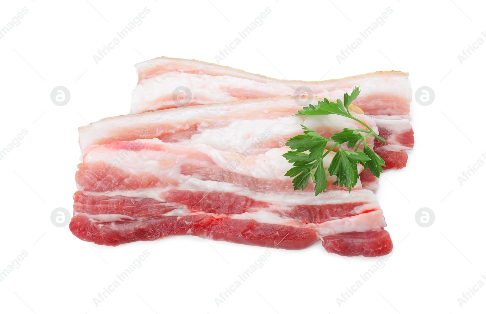 Photo of Pieces of raw pork belly and parsley isolated on white