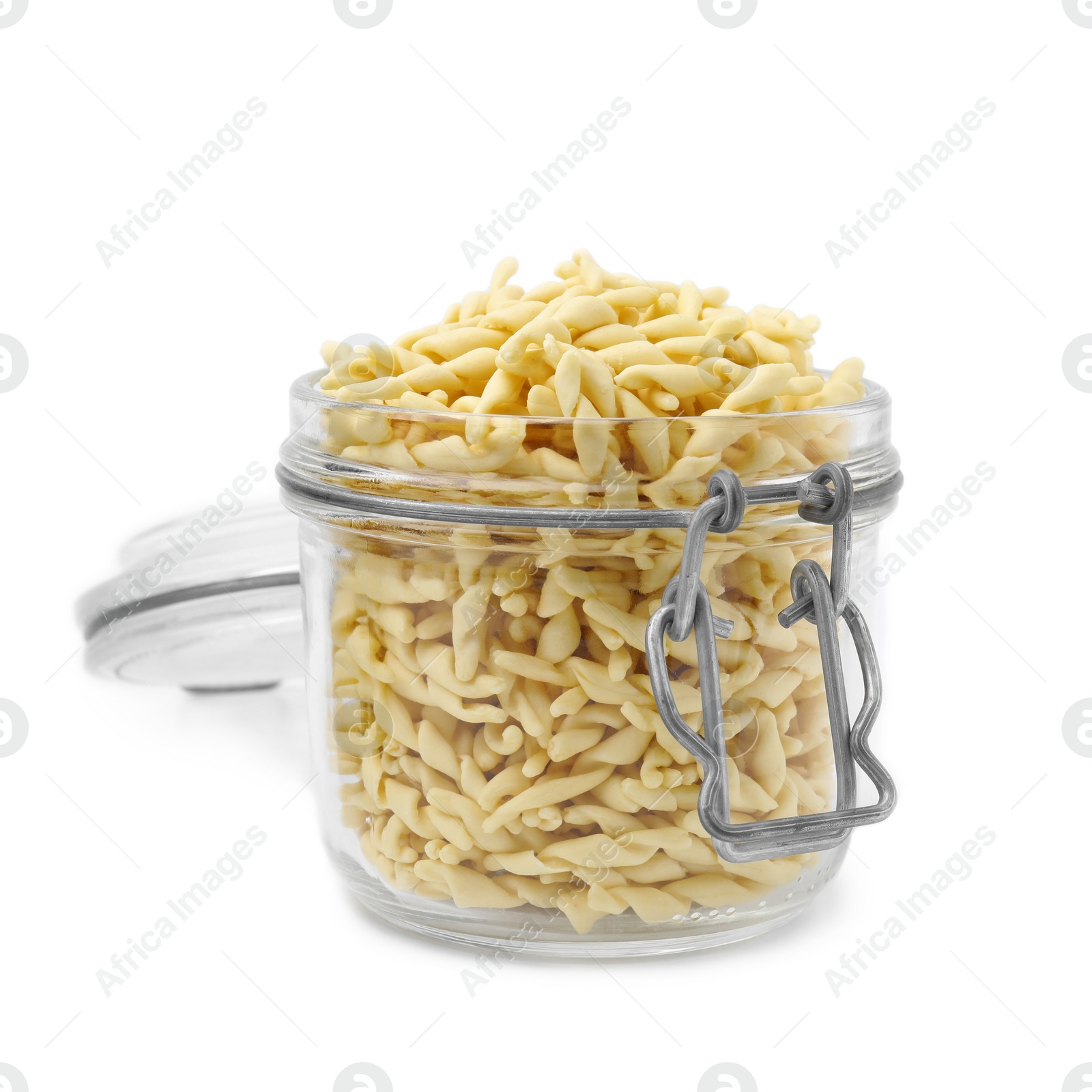 Photo of Uncooked trofie pasta in glass jar isolated on white