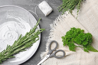 Flat lay composition with rosemary on table. Aromatic herbs