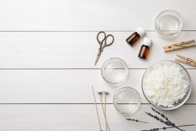 Photo of Flat lay composition with homemade candles ingredients on white wooden background. Space for text