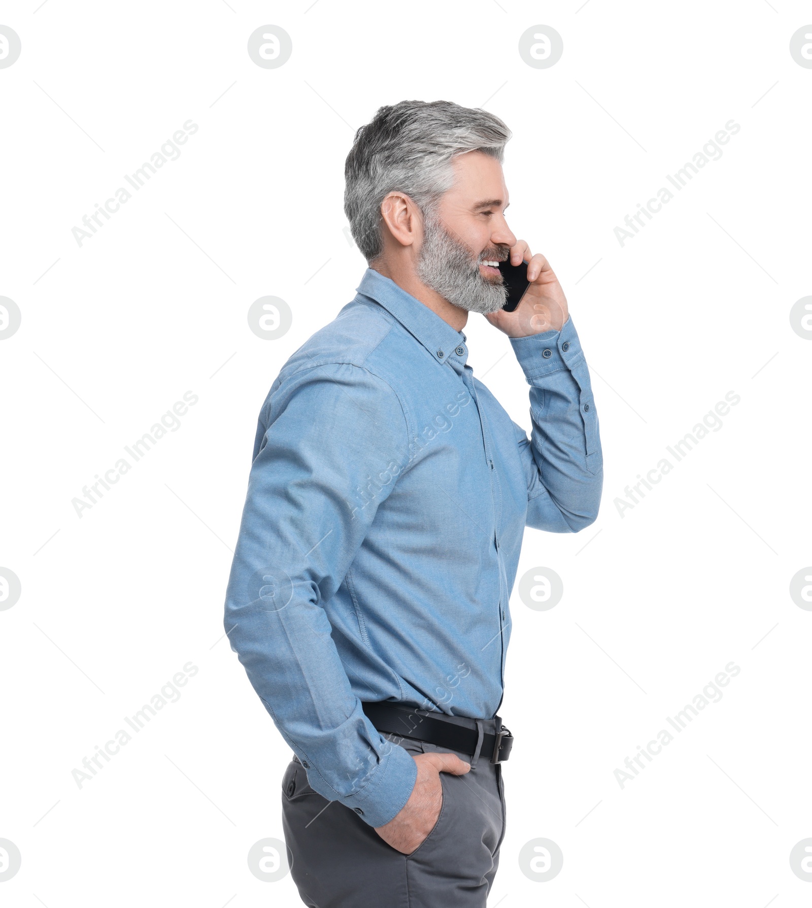 Photo of Mature businessman in stylish clothes talking on smartphone against white background