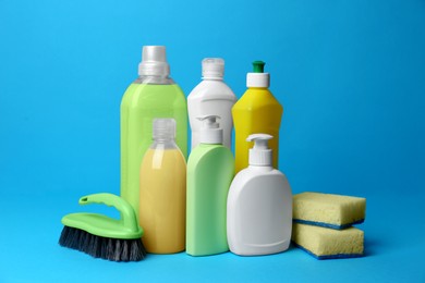 Cleaning supplies and tools on light blue background