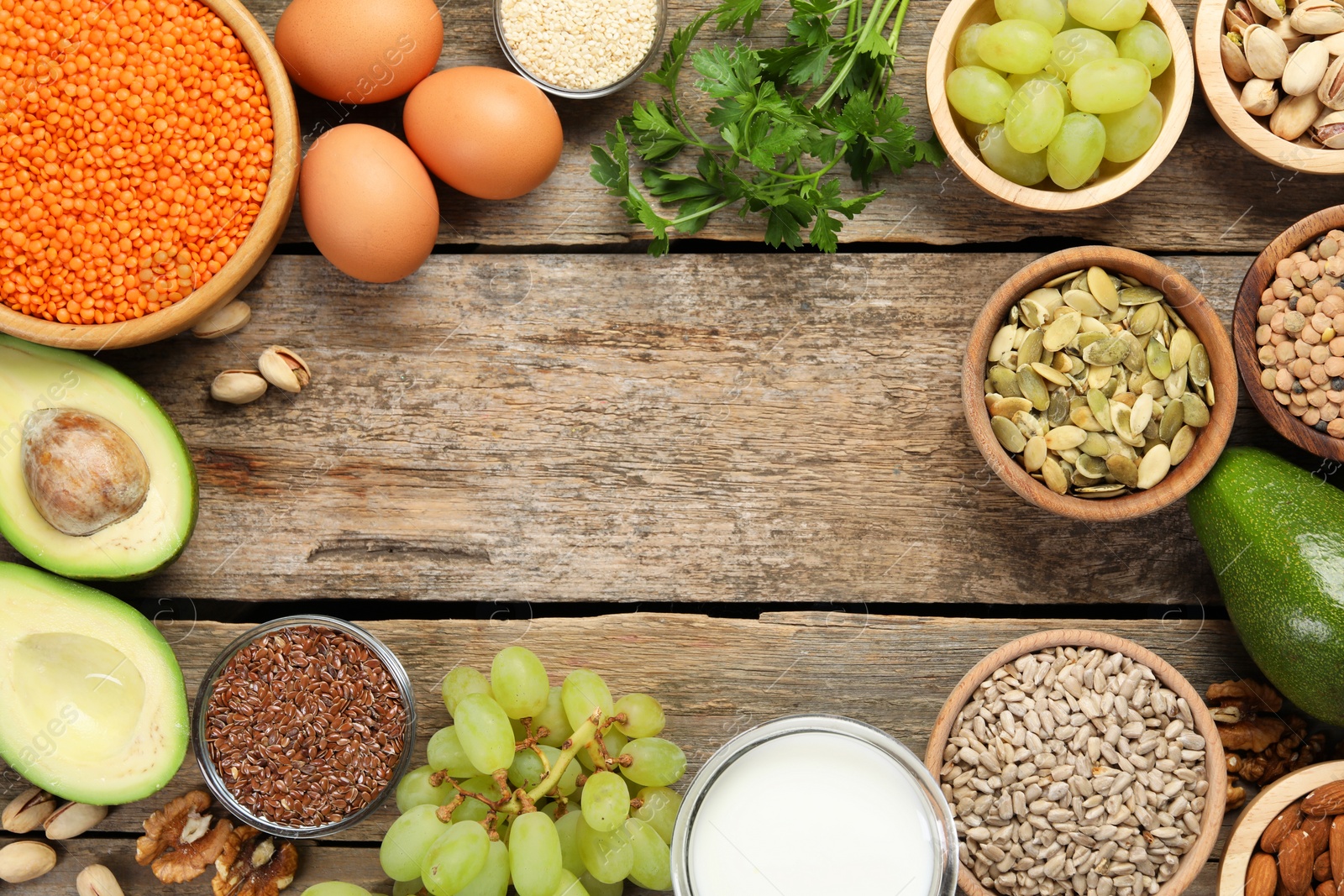 Photo of Different products high in natural fats on wooden table, flat lay