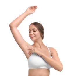 Young woman with smooth clean armpit on white background. Using deodorant