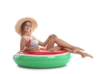 Photo of Sexy young woman in bikini with inflatable ring and coconut cocktail on white background