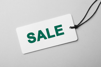 Image of Tag with text SALE on light background, top view. Black Friday 