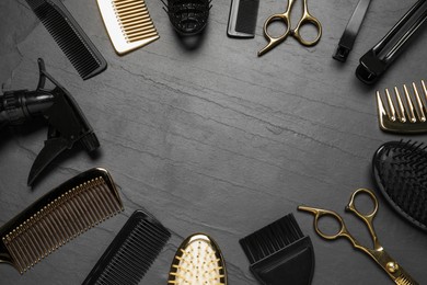 Photo of Frame of hairdressing tools on grey textured background, flat lay. Space for text