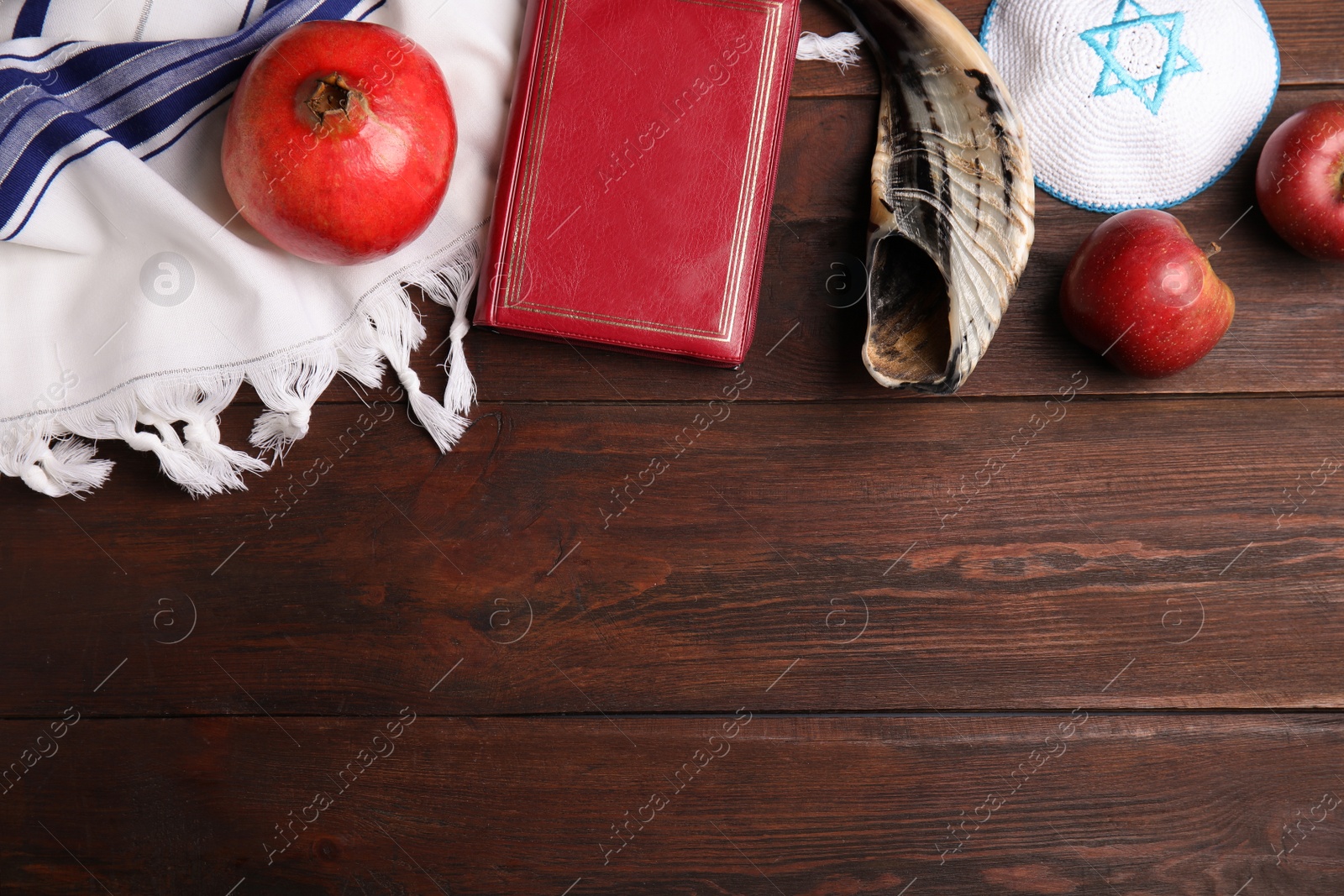 Photo of Flat lay composition with Rosh Hashanah holiday symbols on wooden table. Space for text