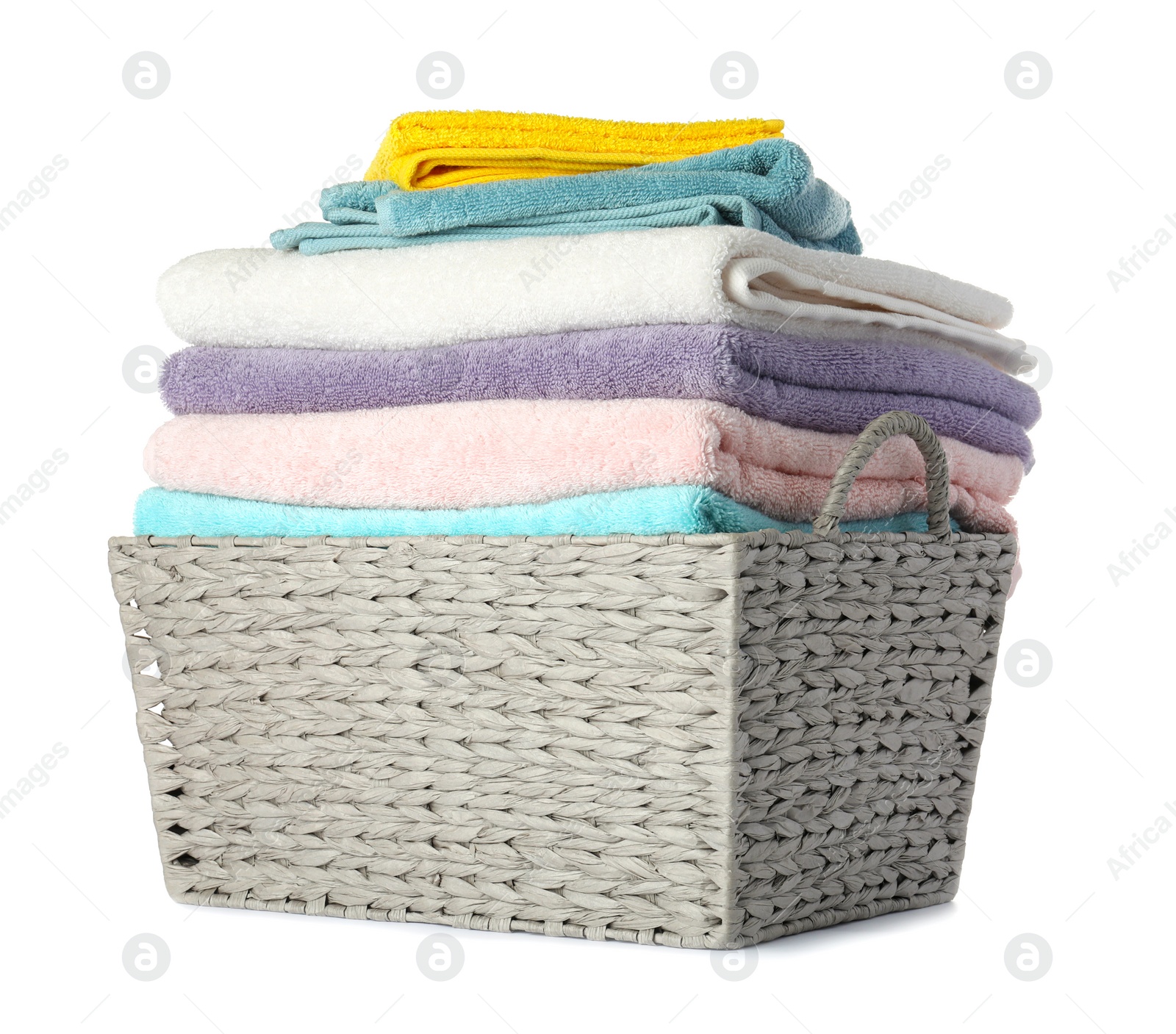 Photo of Wicker laundry basket with clean towels on white background