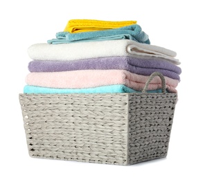 Wicker laundry basket with clean towels on white background