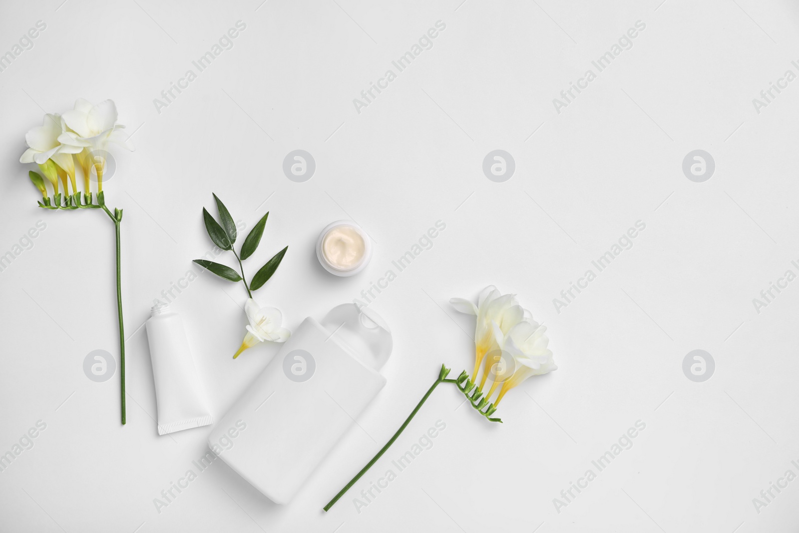 Photo of Flat lay composition with cosmetic products on light background