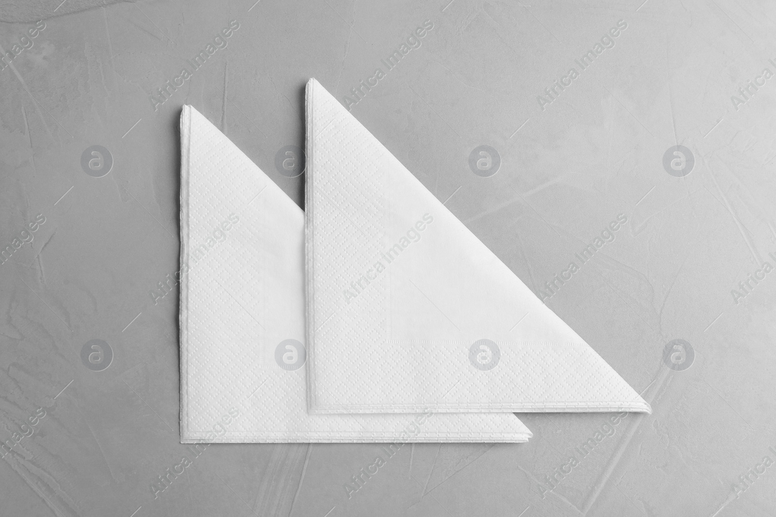 Photo of Clean napkins on light table, top view