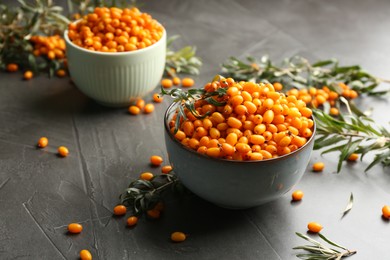 Fresh ripe sea buckthorn on grey table