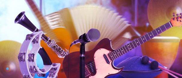 Image of Creative banner design. Modern microphone and different musical instruments