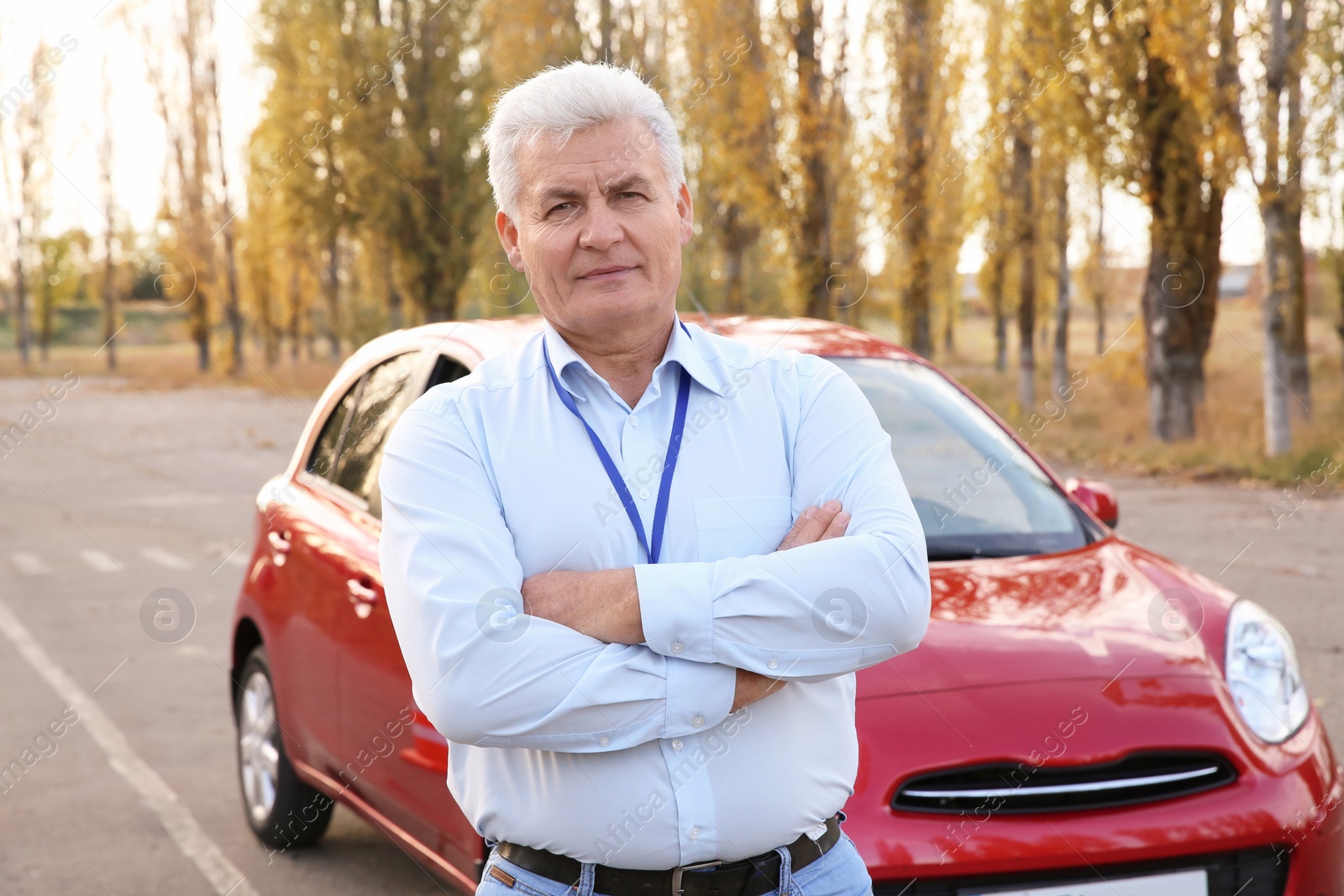 Photo of Senior instructor near modern car outdoors. Get driving license