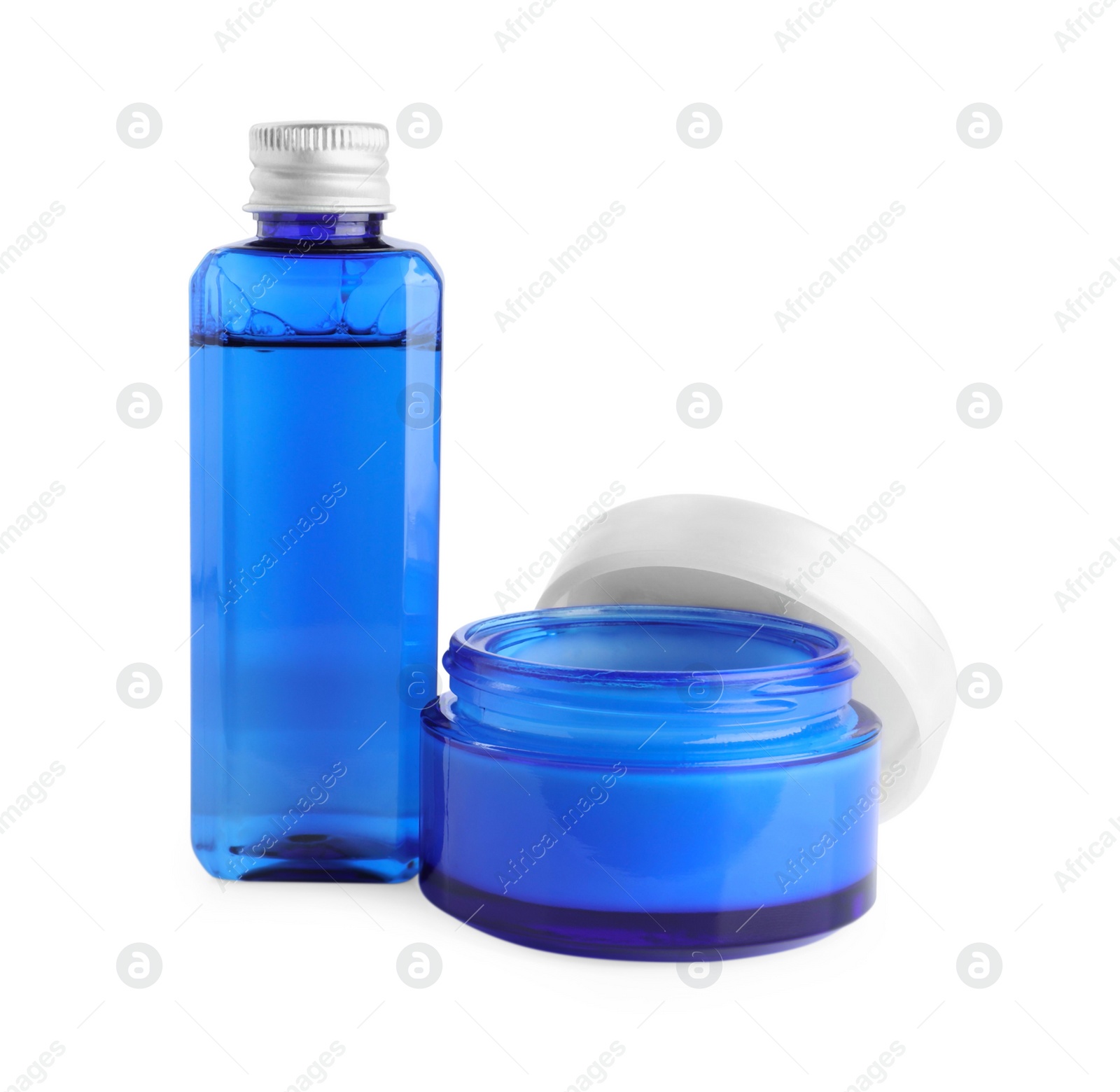 Photo of Jar and bottle of cosmetic products isolated on white