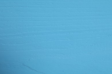 Texture of light blue wooden surface as background, closeup