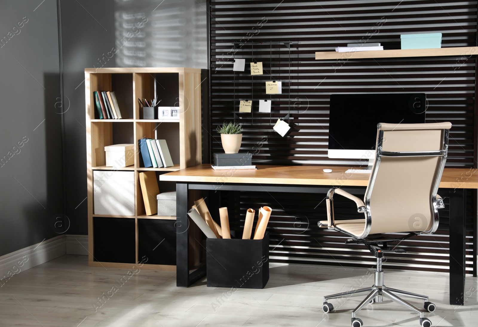 Photo of Comfortable workplace with computer and office chair. Stylish room interior