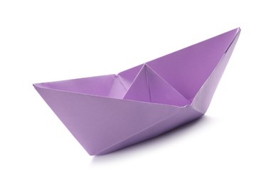 Photo of Handmade violet paper boat isolated on white. Origami art