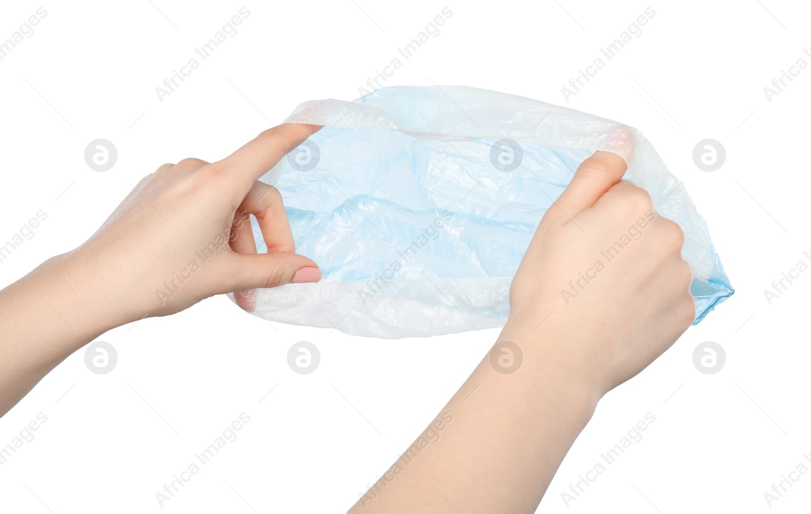 Photo of Woman holding blue shoe cover on white background, closeup