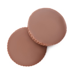 Delicious peanut butter cups on white background, top view