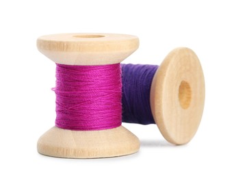 Photo of Different colorful sewing threads on white background, closeup
