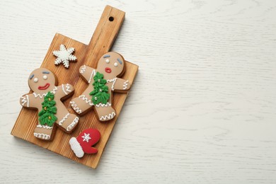 Photo of Delicious Christmas cookies on white wooden table, top view. Space for text