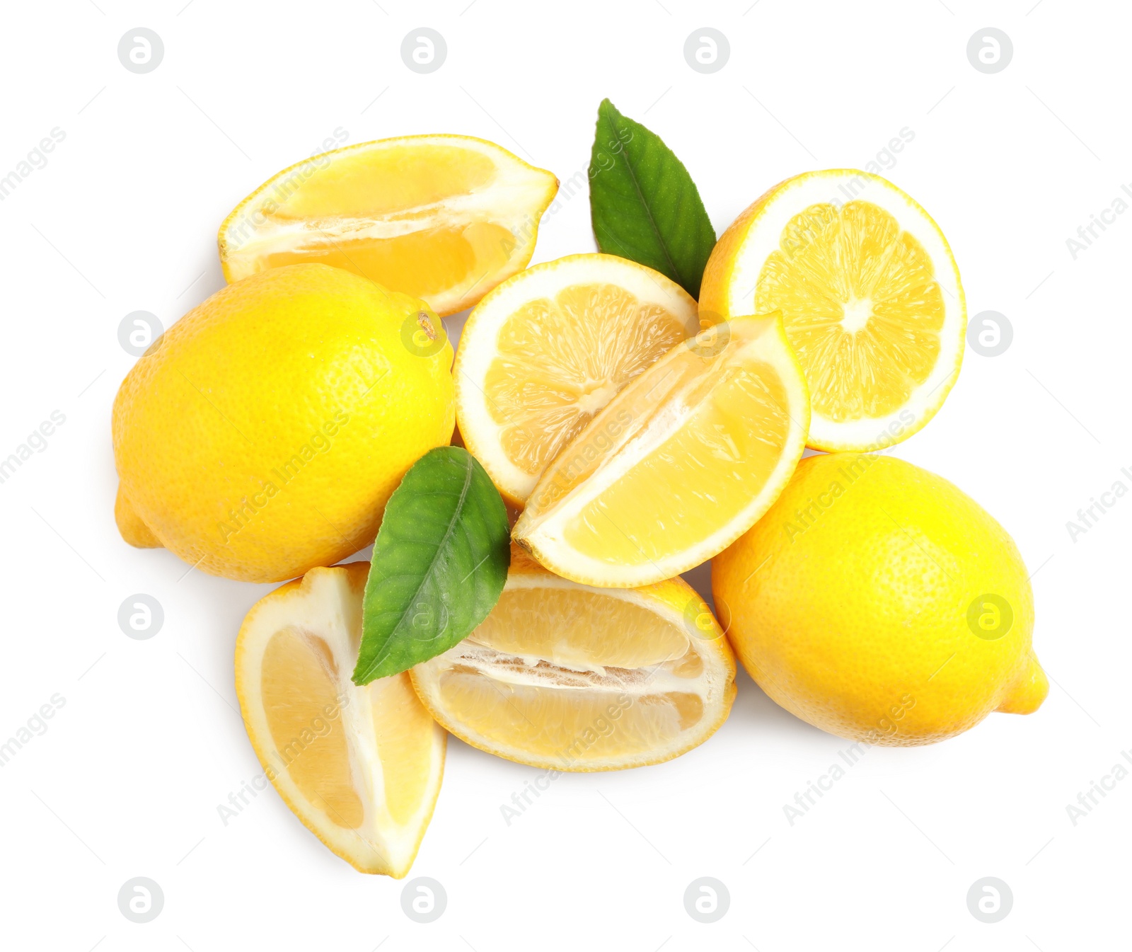 Photo of Cut and whole ripe lemons with green leaves on white background, top view