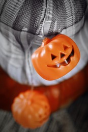 Photo of Pumpkins and jack-o'-lantern lights, closeup view. Halloween decorations