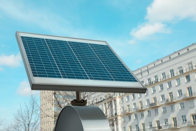 Photo of Small solar panel on city street. Alternative energy