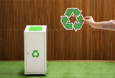 Closeup view of woman with recycling symbol and blurred trash bin on background. Space for text