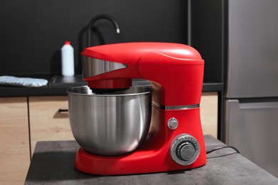 Photo of Modern stand mixer on grey table in kitchen