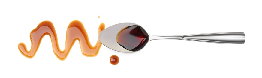 Photo of Tasty soy sauce and spoon isolated on white, top view