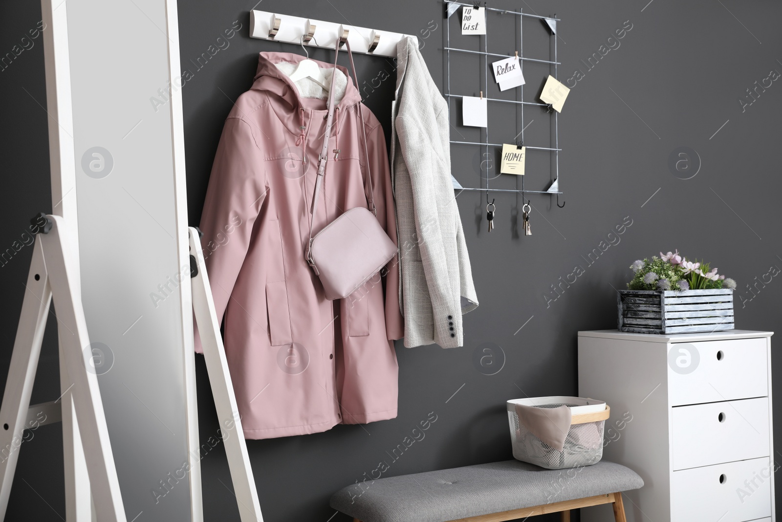 Photo of Hallway interior with stylish furniture, clothes and accessories
