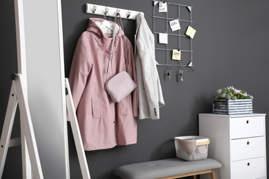 Photo of Hallway interior with stylish furniture, clothes and accessories
