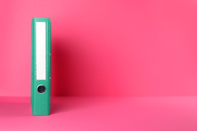 Photo of Green office folder on pink background, space for text