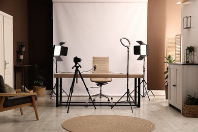 Photo of Modern blogger's workplace with professional equipment in room