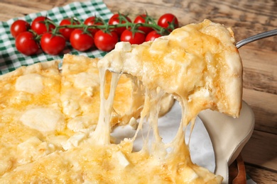 Taking tasty homemade pizza slice with melted cheese, closeup