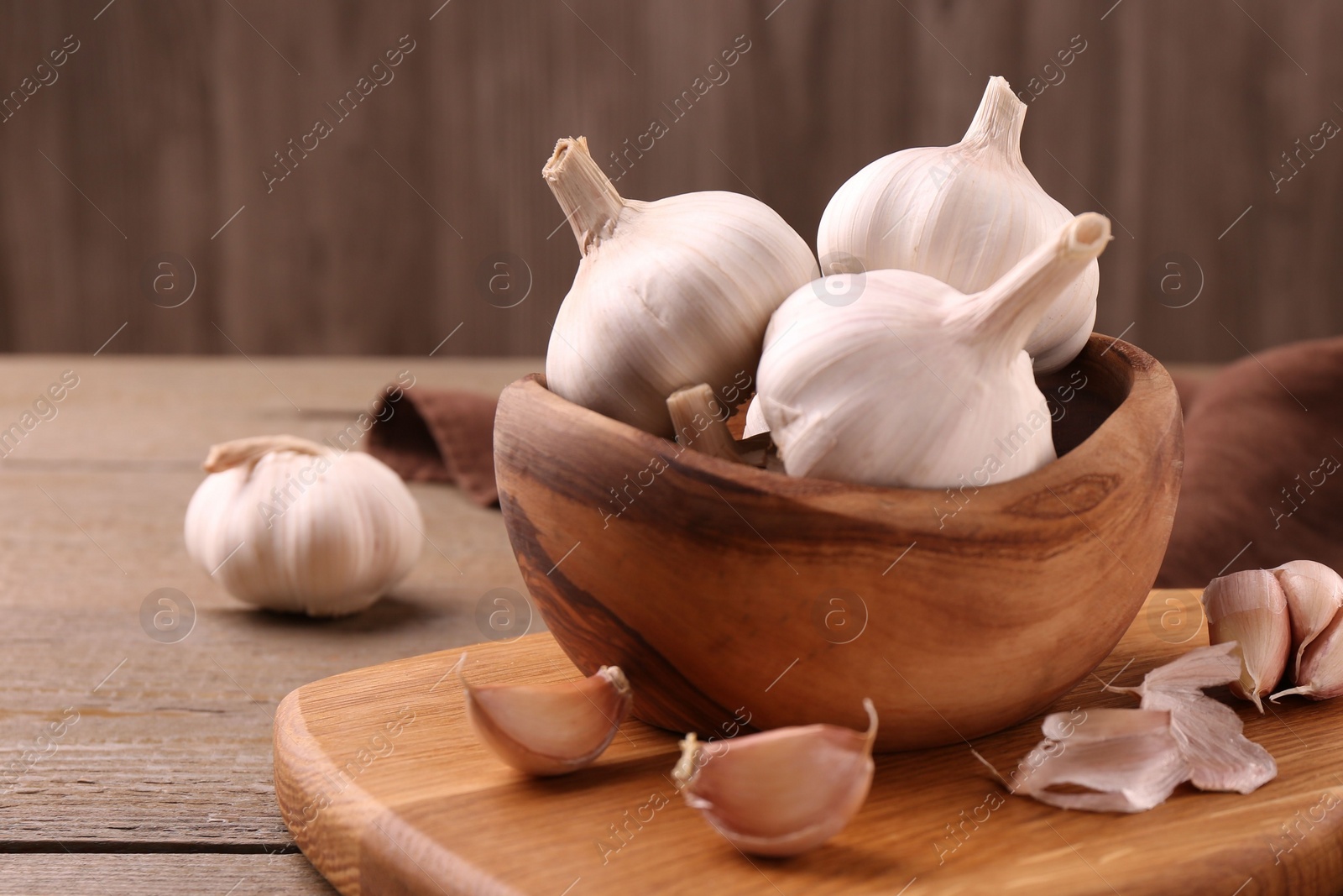 Photo of Fresh garlic on wooden table, closeup. Space for text