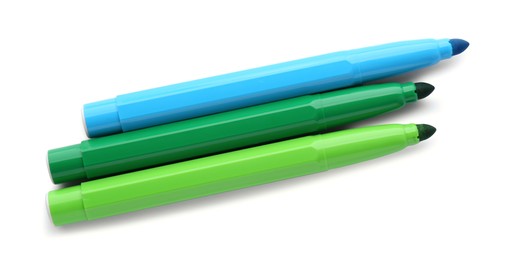 Different colorful markers on white background, top view