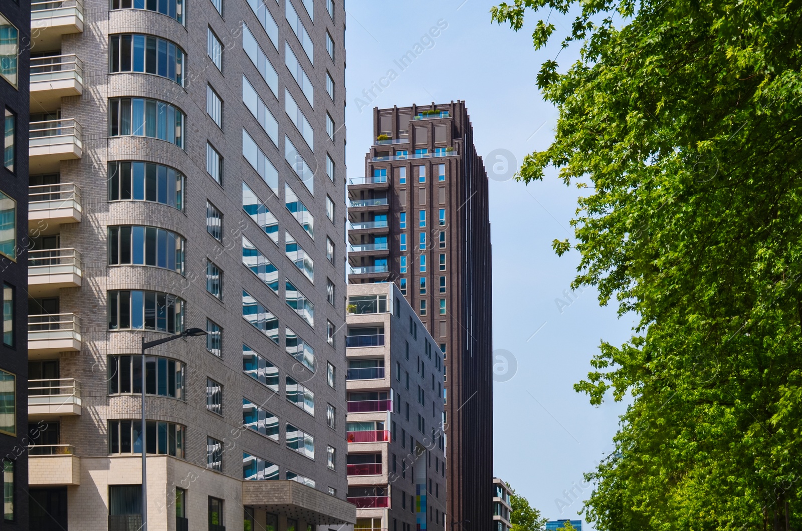 Photo of Exterior of beautiful modern skyscraper against blue sky