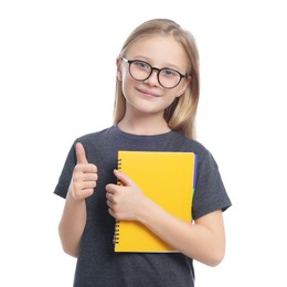 Photo of Cute girl in glasses with books showing thumb up on white background