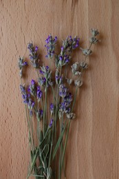 Bouquet of beautiful lavender flowers on wooden table, top view