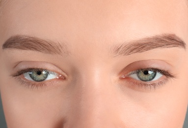 Photo of Young woman with beautiful natural eyelashes, closeup
