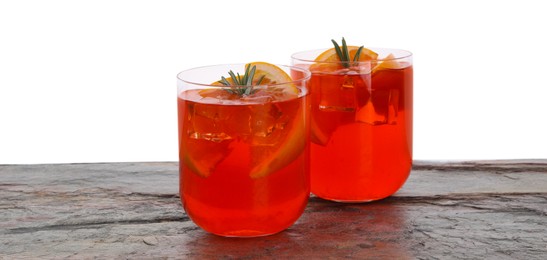 Photo of Aperol spritz cocktail, orange slices and rosemary in glasses on grey textured table against white background