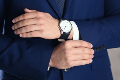 Man in formal suit with modern watch, closeup