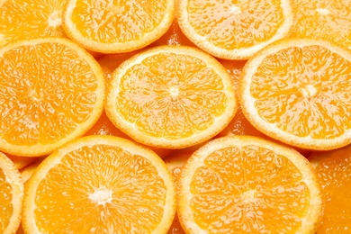 Juicy orange slices as background. Citrus fruit